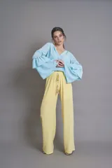 Pantalón palazzo amarillo pastel con cintura elastizada y lazo decorativo.