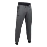 Pantalón de jogging Under Armour, color gris jaspeado, con cintura elástica ajustable con cordón, puños en los tobillos y bolsillos laterales con cierre. Presenta el logo de la marca estampado en la pierna derecha.