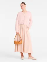 Bolso pequeño tipo baguette de cuero color caramelo, con correa ajustable para llevar al hombro o cruzado.