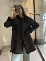 Campera tipo gamulán de cuero genuino con efecto desgastado, cuello de corderito y cierre frontal con botones.