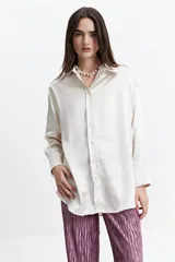 Camisa color verde oliva de manga larga confeccionada en tela satinada.