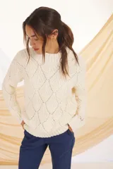 Sweater de punto color crudo con diseño calado.