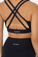 Top deportivo de sujeción media, confeccionado en poliamida y elastano. Presenta un diseño con escote redondo, breteles finos y banda elástica en la cintura para mayor ajuste y soporte. Cuenta con doble tela interna para mayor seguridad durante el entrenamiento.