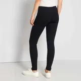 Legging negro liso con costuras verticales en el frente.