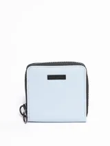 Billetera pequeña cuadrada color celeste con cierre de cremallera negra y logo de la marca en placa metálica negra.