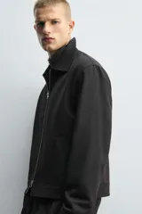 Sobrecamisa regular fit color gris oscuro, confeccionada en tejido con viscosa. Presenta cuello solapa, manga larga con puño abotonado, bolsillos de vivo en la cadera y cierre frontal con cremallera.