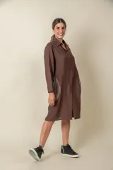 Túnica marrón de viscosa texturizada con cierre de botones, bolsillos laterales y detalle de rayas verticales en los bolsillos.