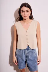 Chaleco de punto color ladrillo, con escote en V y cierre frontal con botones.