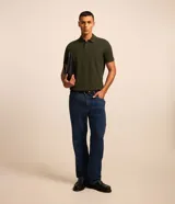 Remera polo de manga corta color verde militar, confeccionada en algodón peruano con cuello convencional y cierre de botones.