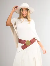 Poncho de corte holgado y diseño minimalista, confeccionado en tejido liviano de color beige, con cuello redondo y caída fluida.