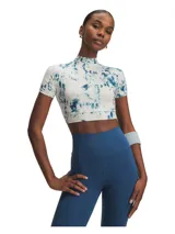 Remera deportiva Under Armour de manga corta, con diseño crop y cuello alto. Presenta un estampado tipo tie-dye en tonos blanco y azul, con el logo de la marca en el pecho.