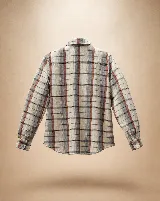 Camisa de algodón a cuadros en tonos vino, piedra y crudo, con pechera frontal decorada con puntillas y volados. Presenta cuello clásico, cierre frontal con botones y mangas largas con volumen sutil.