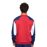 Buzo deportivo Umbro del Club Nacional de Football, con diseño en color bordó, mangas azul marino con detalles en blanco, cuello redondo y puños elásticos.