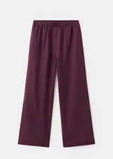 Pantalon de lino color bordo, de corte recto y tiro medio, con cintura elastizada y bolsillos laterales.