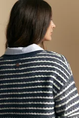 Sweater de punto con diseño de rayas horizontales en tonos tierra, con textura acanalada y cuello redondo. Presenta un corte relajado y mangas largas.
