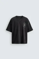 Sudadera de manga corta con corte relajado, confeccionada en algodón con interior de rizo. Presenta cuello redondo con detalle de costura en V, efecto lavado y estampado gráfico en el frente.