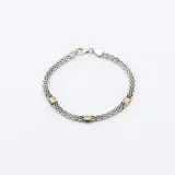 Pulsera de plata y oro con eslabones tipo Bismark.