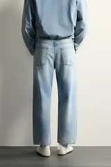 Jeans de corte regular cropped confeccionados en denim ligero de algodón. Presentan un diseño de cinco bolsillos con efecto lavado, tiro medio y cierre frontal con botones.