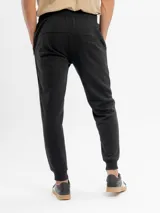Pantalón de jogging de felpa color gris melange, con corte ajustado, cintura elástica con cordón de ajuste y bolsillos laterales con cierre.