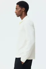 Remera polo de manga larga H&M en punto jacquard de mezcla de algodón, con cuello clásico, tapeta con botones y corte ajustado.