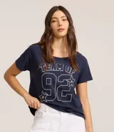 Remera de algodón azul marino con cuello redondo y mangas cortas. Presenta un diseño gráfico en el frente con el texto 'TEAM OF 92' y detalles de estrellas estampadas en contorno blanco.