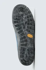 Zapatilla de cordones con diseño de inspiración montañista, confeccionada en piel con acabado de serraje en color azul. Presenta una puntera y refuerzo lateral en gamuza gris con textura desgastada, horma redonda y suela de goma dentada VIBRAM®.