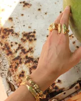 Pulsera artesanal compuesta por una serie de cuentas metálicas irregulares ensartadas en un hilo de algodón natural. Diseño rústico y minimalista.