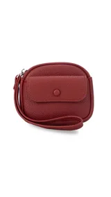 Monedero compacto de símil cuero con textura granulada, cuenta con un compartimento principal con cierre, correa de mano y un bolsillo frontal con solapa y botón a presión.