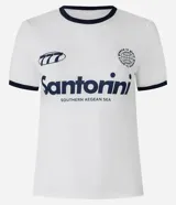 Remera estilo ringer de algodón color blanco crudo, con cuello redondo y ribetes en contraste azul marino en el cuello y mangas. Presenta un estampado frontal con la palabra "Santorini" y un gráfico estilizado.