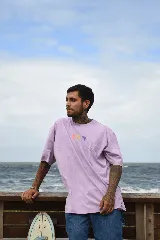 Remera negra de algodón con cuello redondo y mangas cortas. Estampado frontal con tres flores de colores.