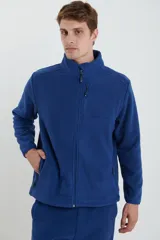 Campera de micropolar color verde oscuro, con cuello alto, cierre frontal completo, bolsillos laterales y un bolsillo con cierre en el pecho.