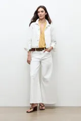 Chaqueta clásica de jean color crudo, con cierre frontal de botones metálicos, bolsillos con solapa en el pecho y cuello camisero.