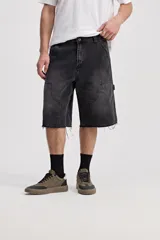 Bermuda carpenter de jean con corte amplio, bolsillos grandes y detalles inspirados en la ropa de trabajo. Presenta un lavado desgastado y ruedo desflecado.