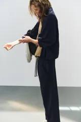 Pantalón de algodón negro con tiro medio, cintura elástica, pierna recta y grandes bolsillos laterales aplicados.