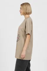 Remera blanca de algodón con cuello redondo, mangas cortas y calce holgado. Cuenta con un estampado frontal de estilo gráfico que dice "Negroni" junto con la ilustración de un trago y rodajas de naranja.