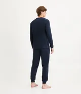 Pijama masculino de dos piezas confeccionado en tejido fleece texturizado. Incluye una remera de manga larga con cuello redondo y puños ajustados, y un pantalón tipo jogger con cintura elástica, cordón de ajuste y bolsillos laterales.