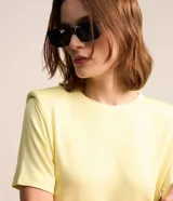 Blusa amarilla de algodón con cuello redondo, mangas cortas y hombreras.