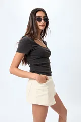 Remera blanca de punto acanalado con escote redondo amplio y mangas cortas.