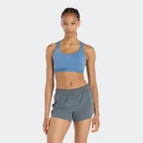 Top deportivo New Balance Essential Train, color azul, de sujeción media, con escote redondo y tirantes anchos que se cruzan en la espalda. Presenta un pequeño logo NB en el centro del pecho.