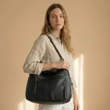 Bolso tipo shopper color negro, confeccionado en eco-cuero con textura premium. Incluye monedero de regalo, cierre superior seguro y bolsillos internos.