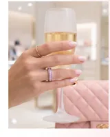 Anillo de plata 925 con diseño de banda ancha, decorado con tres filas de circonias brillantes, siendo la fila central de color rubí y las laterales blancas.