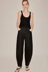 Jeans de tiro alto en denim azul oscuro, de corte tapered y diseño bombacho con pinzas frontales. Cuenta con bolsillos clásicos y costuras en tono tabaco.