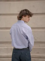 Camisa de corte clásico con estampado de cuadros en tonos rosados y celestes, con cuello abotonado, manga larga y bolsillo frontal con detalle bordado.
