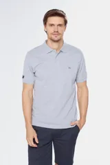 Remera polo de manga corta en tejido piqué color celeste. Presenta cuello clásico con botones, bordado pequeño en el pecho y detalles en tela oxford en el interior del cuello.