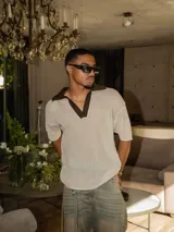 Chomba de tejido de punto abierto color crudo con cuello polo en color marrón chocolate.