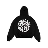 Hoodie oversize negro con capucha y bolsillo tipo canguro, confeccionado con un gran estampado circular blanco en la espalda que presenta la inscripción "Glassy Waves" en tipografía fluida y psicodélica.