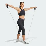 Calza capri deportiva Adidas Techfit de color negro, con diseño de compresión y tiro alto. Presenta una cintura elástica ancha con la inscripción "TECHFIT" repetida y el logo de la marca en blanco en la pierna izquierda.