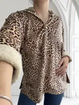 Buzo con capucha y cierre parcial con cremallera, de corte holgado y estampado animal print. Tiene puños y ruedo con ribete de piel sintética.