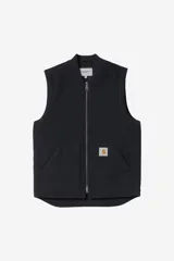 Chaleco de trabajo Carhartt WIP, color azul marino, con cierre frontal completo, cuello tipo bomber y bolsillos delanteros. Presenta el logo de la marca bordado en el pecho.