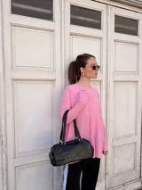 Buzo de viscosa color rosado con textura acanalada, de corte holgado y manga larga.